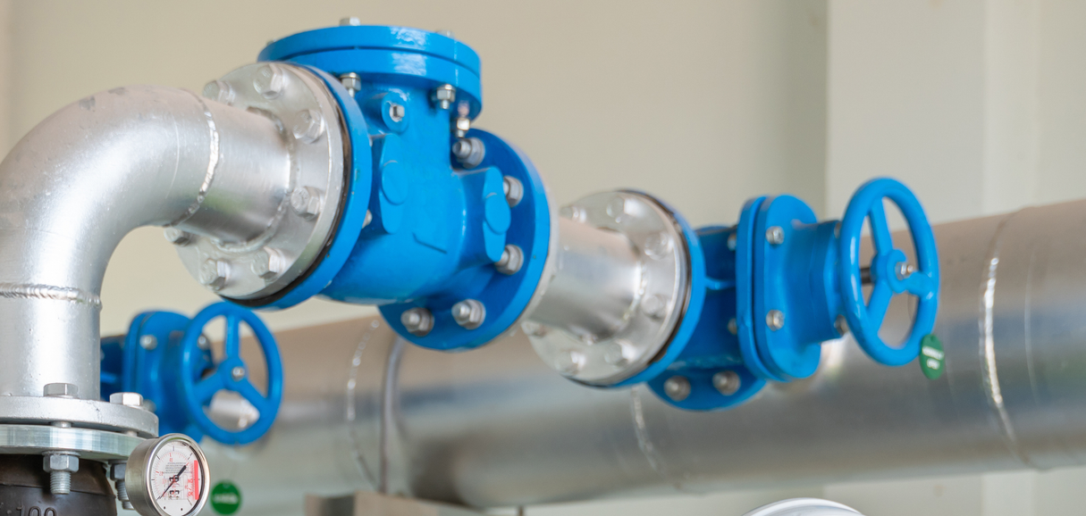 Industrial green check valves installed on a pipeline system